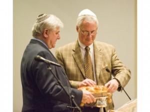 University Synagogue Rabbi Arnold Rachlis, left, gives Irvine United Congregational Church Rev. Paul Tellstrom some special holiday bread, which is part of Jewish tradition, when the two men hosted an Interfaith Thanksgiving service Tuesday night at University Synagogue. Photo: Rod Veal