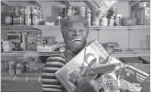 Inside the trailer that houses the Friendship Foundation Food & Clothing Pantry, Gloria Banks shows off her wares.
